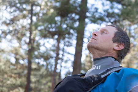 Professional kayaker Ben Stookesberry meditates by the river with his eyes closed.  (National Geographic/Harrison Gayton)