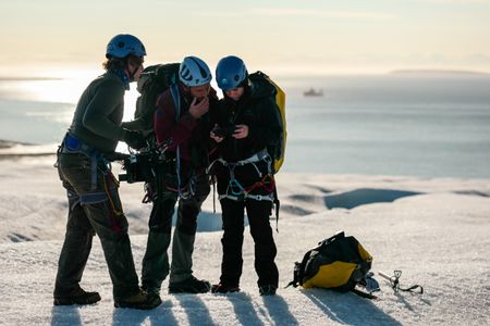 Cameraman Jamie Holland films Andreas Alexander and Melissa Marquez operating a drone on a Svalbard glacier. (National Geographic/Mario Tadinac)
