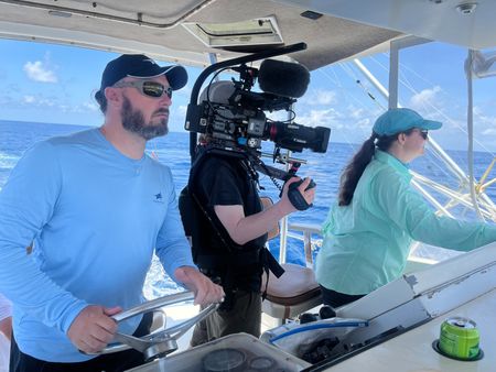 Turtle researcher Ryan Welsh, Camera Operator Jimmy Cape, and Turtle Researcher Katrina Phillips  on a boar in Maui, HI. (National Geographic for Disney/Ruth Davies)
