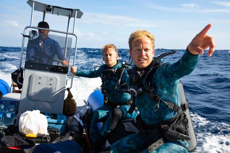 Captain, Paulo Gaspar, steering the rib with underwater cameraman, Jeff Hester and host, Bertie Gregory, as Bertie directs the way.  (credit: National Geographic/Adam Boyle)