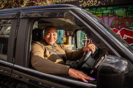 Marie-Louise Samuels poses in the window of her taxi. (National Geographic/Richard Ing)