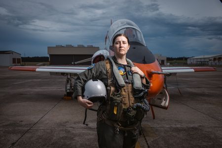 Student LT Carissa Meinster poses in front of a T-45. (Credit: National Geographic/Freddie Claire)
