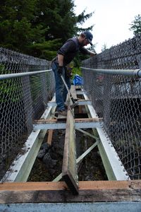 Matt Carlson helps repair a gangway. (National Geographic/Wes Waters)