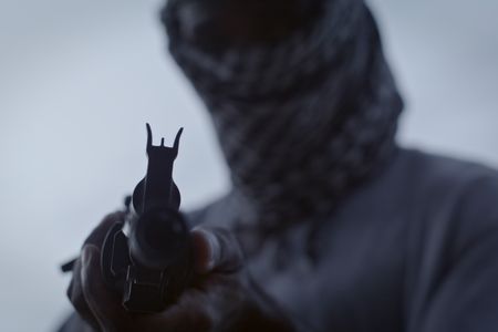 A reenactment of a Somali pirate aiming a sub-machine gun. (©2019 MCN International Pte Ltd. All Rights Reserved.)