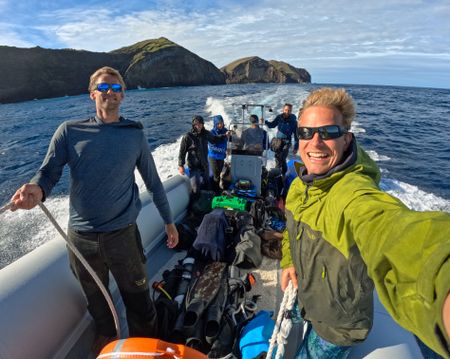 Underwater cameraman, Jeff Hester, left, host Bertie Gregory, right, and crew on board the rib.  (credit: National Geographic/Bertie Gregory)