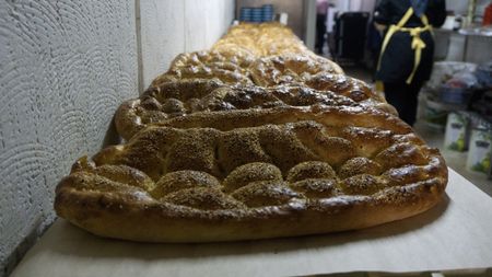 Freshly baked Ramadan Pide is displayed at Master Baker Sami Eryılmaz's bakery, Tophane Tarihi Tas Firin, in Istanbul. Eryılmaz's and other Turkish bakers make this bread one month a year, to celebrate the Muslim holiday of Ramadan. (National Geographic/Madeline Turrini)
