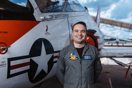 Commander Justin Estrada poses next to his T-45. (Credit: National Geographic/Freddie Claire)