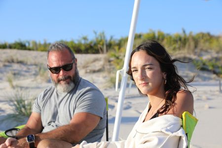 Philip and Lola Pollina in deck chairs on the beach looking into the camera. (National Geographic/Mariana Kneppers)