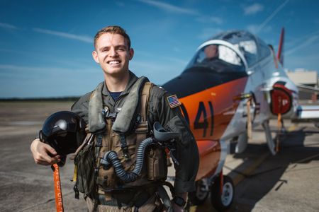 Student LTJG Evan Morris posing in front of a T-45. (National Geographic/Freddie Claire)