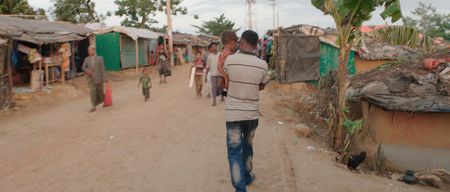 Kamal Hussein carries Dokana, a lost girl, through the refugee camp. Lost and Found, directed by Academy Award winner Orlando von Einsiedel (“The White Helmets”, “Virunga"), is an inspiring story of humanity and heroism in the world’s largest refugee camp, that follows Kamal Hussein, a Rohingya refugee who has dedicated his life to reuniting children with their parents. (Nobel Media)