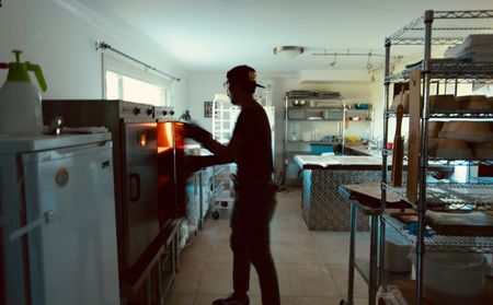 Justin Gomez works in his basement bakery in Martinez, Calif. A cottage baker, Justin produces naturally leavened breads through his home business, Humble Bakehouse. (National Geographic/Ryan Rothmaier)