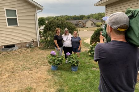 Denise Santille, Rae Ann Calai, and Melissa Slates, sisters of the Doe, are filmed by the memorial stone for their brother, Michael Leach.(National Geographic/Louise Haines)