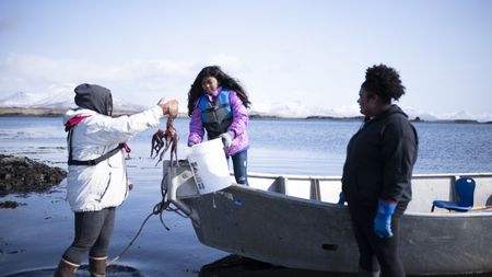 Marcella Amodo-White with her children, collecting food from the tides. (National Geographic/Ashton Hurlburt)