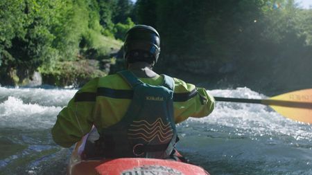 Chris Korbulic kayaking toward whitewater.(photo credit: National Geographic/Pablo Durana)