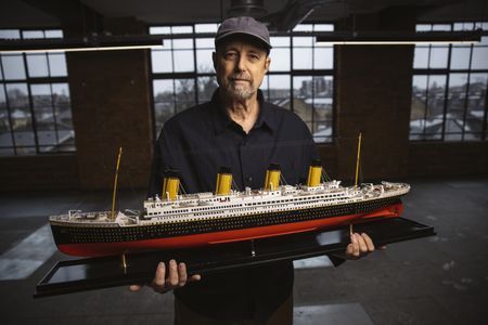 Parks Stephenson stands with a model of RMS Titanic. (National Geographic/Freddie Claire)
