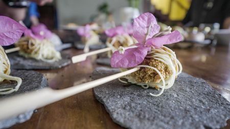 Restaurant owner and Chef Rolando Chamorro tops a dish with an edible flowerat his restaurant in Hacienda Mamecillo, Boquete, Panama. (National Geographic for Disney/Missy Bania)