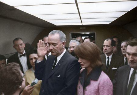 This colorized archival image shows the swearing-in ceremony of Lyndon B. Johnson (LBJ) as President aboard Air Force One with former first lady Jacqueline Kennedy standing next to him, Nov. 22, 1963, in Dallas. (Cecil Stoughton/White House Photographs/John F. Kennedy Presidential Library and Museum, Boston)