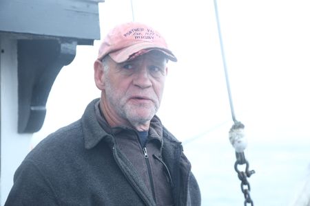 Sam Carlson fishes for salmon near the end of the summer troll season. (National Geographic/Wayne Moss)
