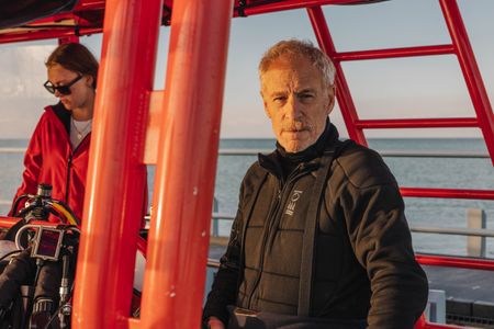 Director and cinematographer, Adam Geiger, on board a dive vessel in Port Phillip Bay.  (photo credit: National Geographic/Harriet Spark)