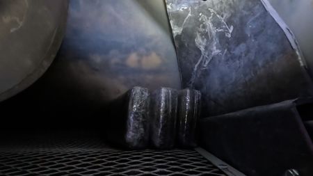 Multiple packages of suspected narcotics are pictured smuggled inside of the refrigeration unit of a cargo truck in Hidalgo, Texas. (National Geographic)