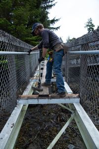 Matt Carlson helps repair a gangway. (National Geographic/Wes Waters)