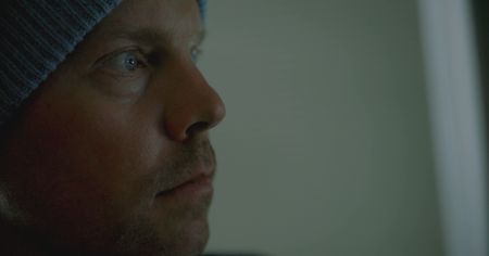 Travis Rice watching his film "The Fourth Phase" where he was caught in an avalanche.  (photo credit: National Geographic/Ross McDonnell)