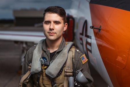 Student LTJG Marcus Figueroa poses next to a T-45. (Credit: National Geographic/Freddie Claire)