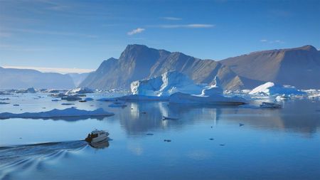 The team boat in the open water surrounded by icebergs.  (photo credit: National Geographic/Pablo Durana)