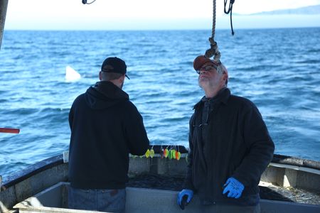Matt Carlson and Sam Carlson fish for salmon near the end of the summer troll season. (National Geographic/Wayne Moss)