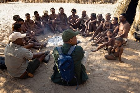 San Bushman Guide Kane Motswana, left, and Will Smith sit and talk with the San people in the Kalahari Desert.  (credit: National Geographic/Kyle Christy)