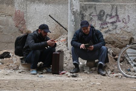 Al Ghouta, Syria - Dr. Salim (R) waits for the evacuation. (National Geographic)