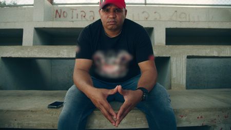 John, a well-connected bookie in the Dominican Republic, speaks to Mariana van Zeller about street racing. (National Geographic)