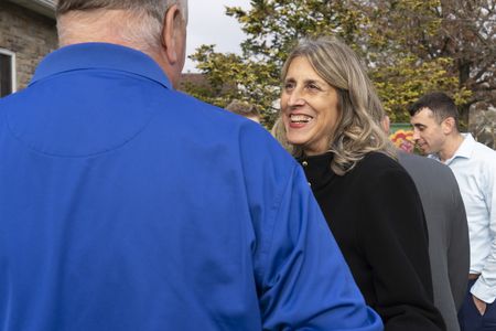 Carol D'Allara smiles while talking with Bill Spade, who was with her husband John D'Allara when he was killed on 9/11. (National Geographic/Virginia Sherwood)