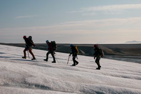PolarX guide Loup Supery, Andreas Alexander, Melissa Marquez, and PolarX guide Tom Lawton hike up a glacier on Svalbard. (National Geographic/Mario Tadinac)