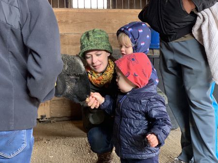 Beth, Abigail, and Silas Pol meet and feed their new sheep, Princess Leia, at the Onstott Family Farm before bringing her to the Pol family's farm. (National Geographic)