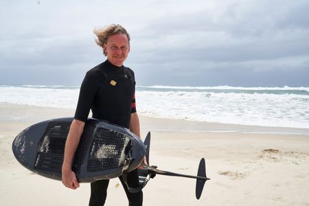 Christian Bungate with his foil board at Cabarita Beach. (National Geographic/Justine Kerrigan)