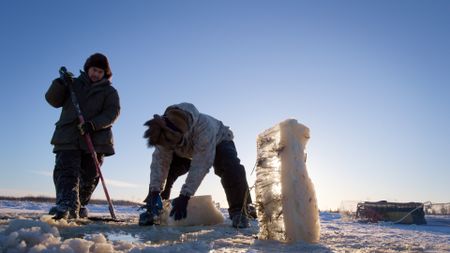 Gage and Avery Hoffman check their blackfish traps under the ice.(BBC Studios/Danny Day)