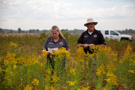 Coroner Scott McCord and Chief Deputy Heidi McCord in the field at the site where the body was discovered in 1983. (National Geographic/Tom Beard)