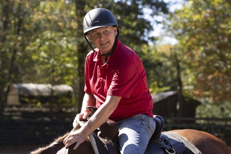 Stefan Horlacher rides a horse during his reunion with Debbie St. John. (National Geographic/Virginia Sherwood)