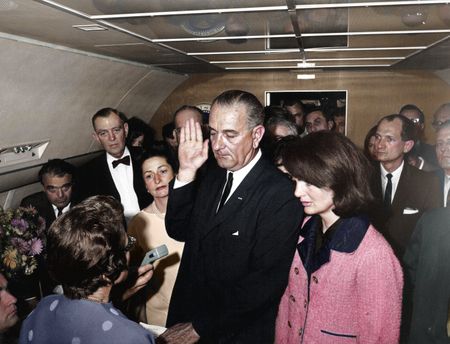 This colorized archival image shows the swearing-in ceremony of Lyndon B. Johnson (LBJ) as President aboard Air Force One with former first lady Jacqueline Kennedy standing next to him, Nov. 22, 1963, in Dallas. (Cecil Stoughton/White House Photographs/John F. Kennedy Presidential Library and Museum, Boston)