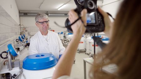 Thomas Hildebrant smiling for photographer, Ami Vitale, at the  BioRescue lab in Berlin, Germany.  (credit: National Geographic)