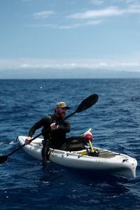 Aldo Kane kayaks in the ocean with a Bobcam buoy on board. (National Geographic/Mario Tadinac)