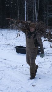 Jamey Joseph helps carry and clear the area for a puppy pen. (National Geographic/Wayne Shockey)