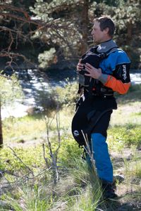 Professional kayaker Ben Stookesberry observes the river as he stands with his hands on his vest.  (National Geographic/Harrison Gayton)