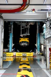 The submarine is lifted up off of deck while Crew Colin Wollerman and Dave Pollock watch. (National Geographic/Mario Tadinac)