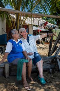 Bunaken resident, Tante Ita, left, and Dr. Crissy Huffard discuss Algae octopus on Bunaken Island. Tante Ita took Dr. Huffard under her wing when she was on Bunaken doing her initial research in 2009. She taught Dr. Huffard Bahasa and helped find locals with knowledge about the Algae octopus (Abdopus aculeatus).(photo credit: National Geographic/Annabel Robinson)