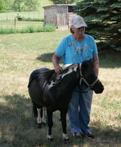 Jonny Binkard stands by Bo, her miniature horse. (National Geographic)