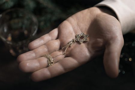 A SMALL LIGHT - The butterfly necklace that was given to Miep folds into a Star of David, as seen in A SMALL LIGHT. (Credit: National Geographic for Disney/Dusan Martincek)