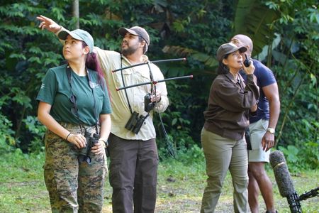 Christian Cooper observes the historic release of 7 Puerto Rican Parrots into the wild with Marisel López-Flores Lopez, the Project Leader of the Puerto Rican Parrot Recovery Program. (National Geographic for Disney)