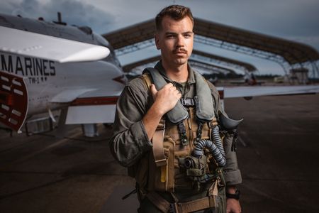 Student 1st Lt Chuck Kent poses behind a T-45. (Credit: National Geographic/Freddie Claire)